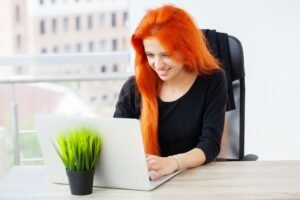 Beautiful business lady working with laptop in office