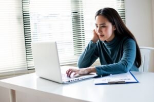 Young pretty Asian woman use laptop on working table